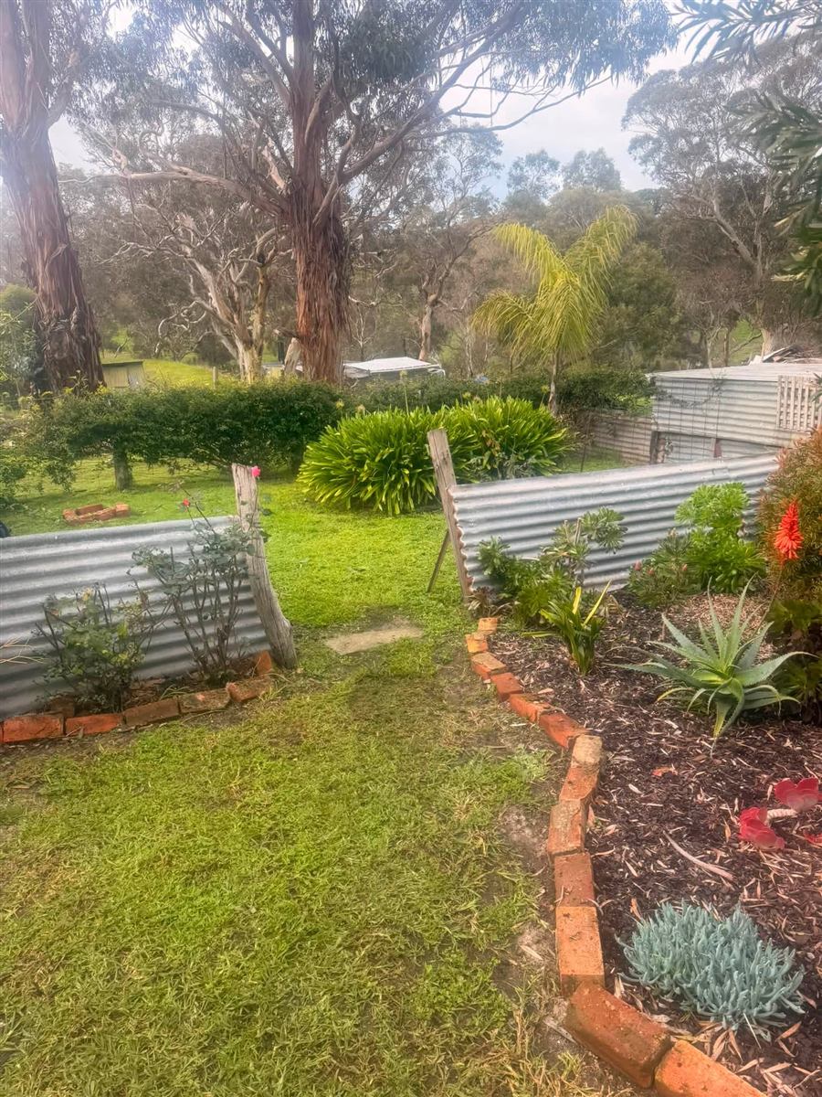 Garden beds weeded and trimmed with a brick edge on the Fleurieu Peninsula